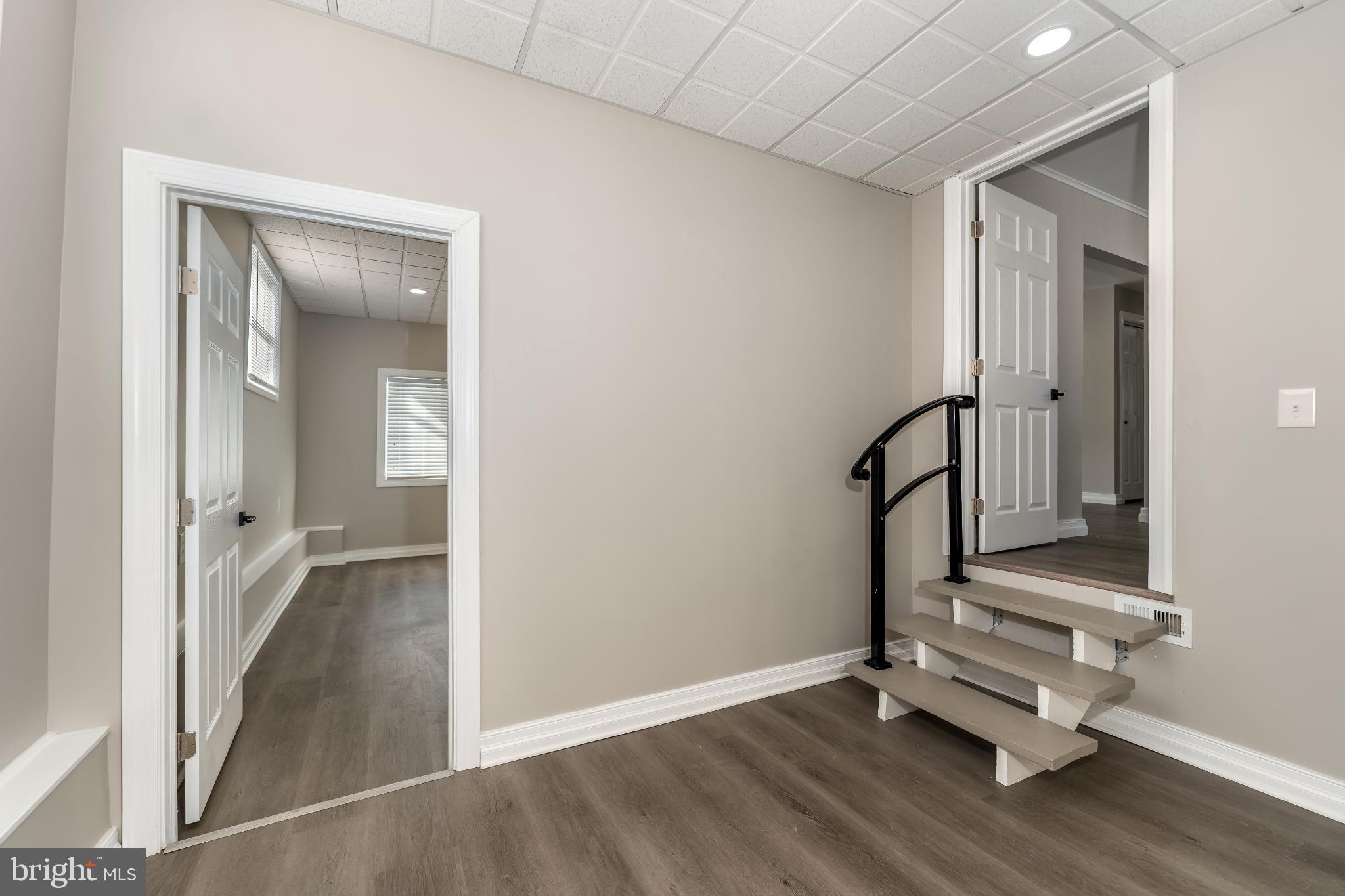 106 Rutherford Road Harrisburg, PA 17109 - Photo 19 of 27 an empty room with wooden floor and windows