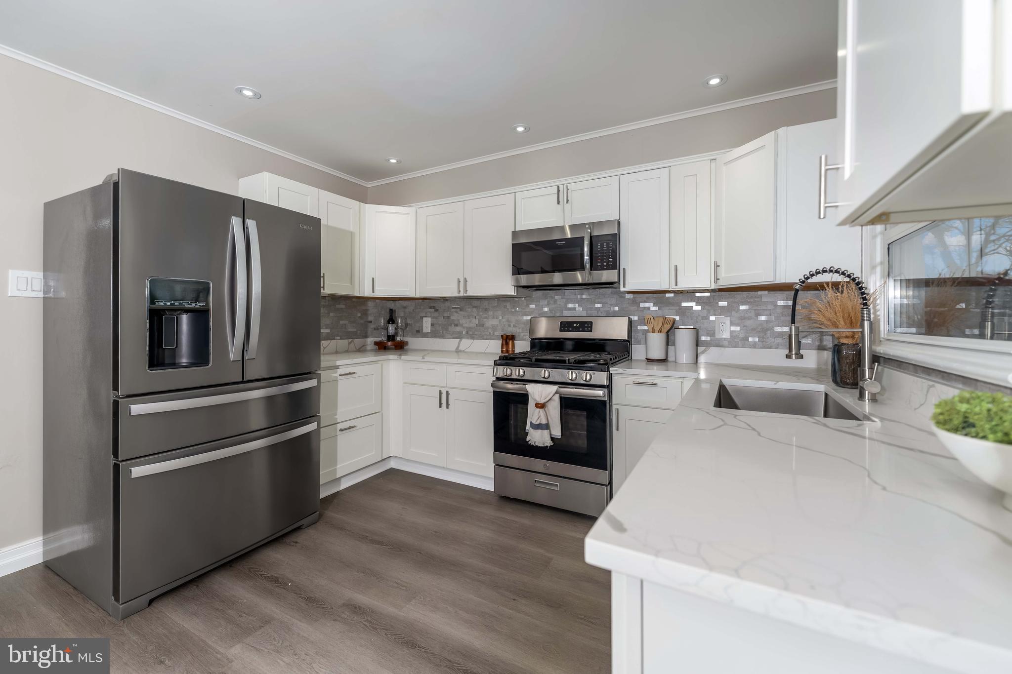 106 Rutherford Road Harrisburg, PA 17109 - Photo 2 of 27 a kitchen with kitchen island a white cabinets and stainless steel appliances