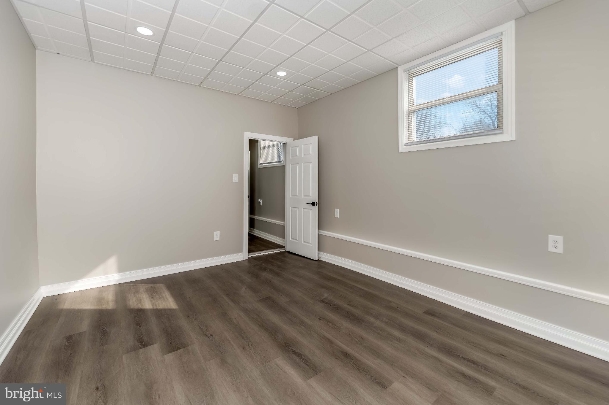 106 Rutherford Road Harrisburg, PA 17109 - Photo 21 of 27 an empty room with wooden floor and windows