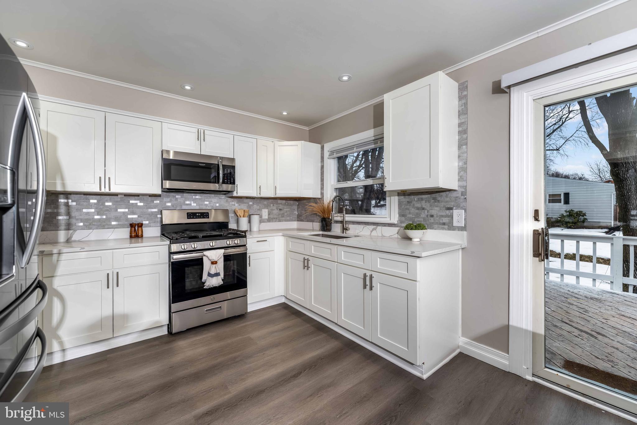 106 Rutherford Road Harrisburg, PA 17109 - Photo 3 of 27 a kitchen with kitchen island granite countertop a sink cabinets and stainless steel appliances