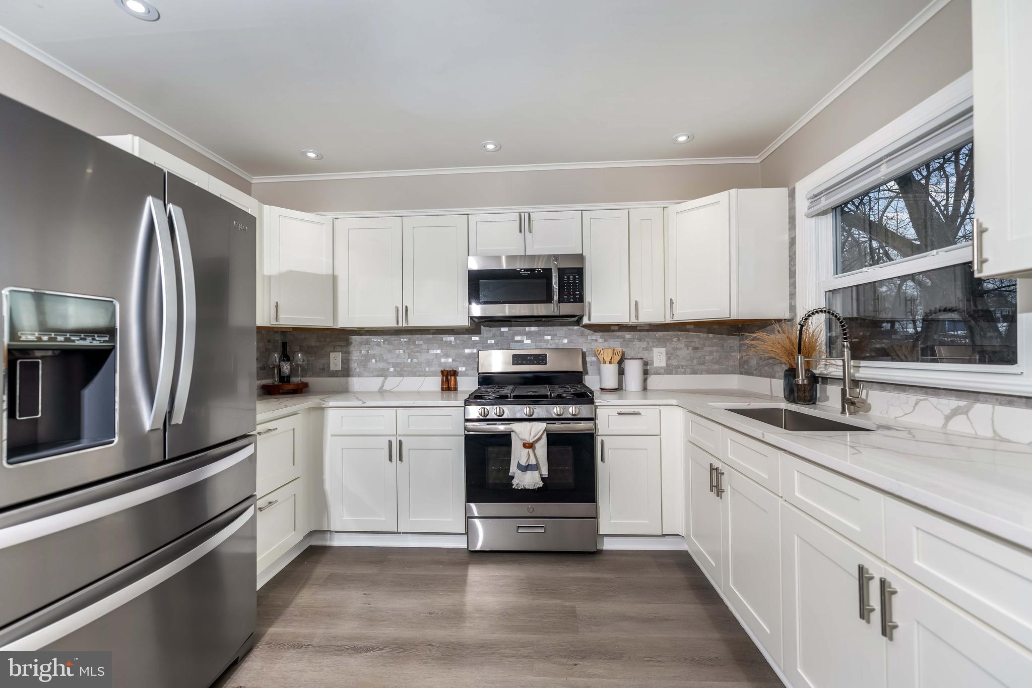 106 Rutherford Road Harrisburg, PA 17109 - Photo 5 of 27 a kitchen with stainless steel appliances granite countertop a stove top oven a sink and a refrigerator