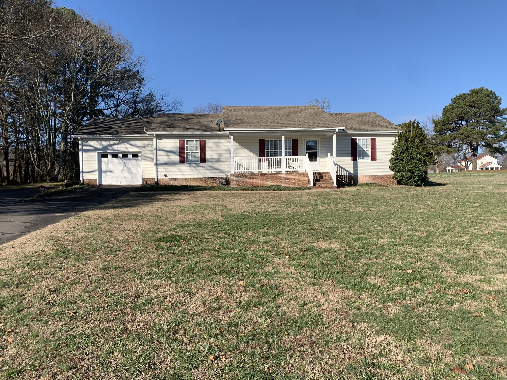 301 Rosson Street Summertown, TN 38483 - Photo 1 of 29 a front view of a house with a garden and yard