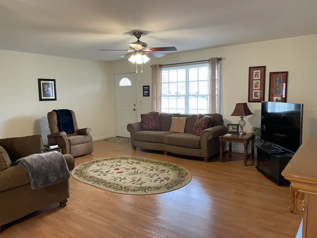 a view of a dining room with furniture and wooden floor