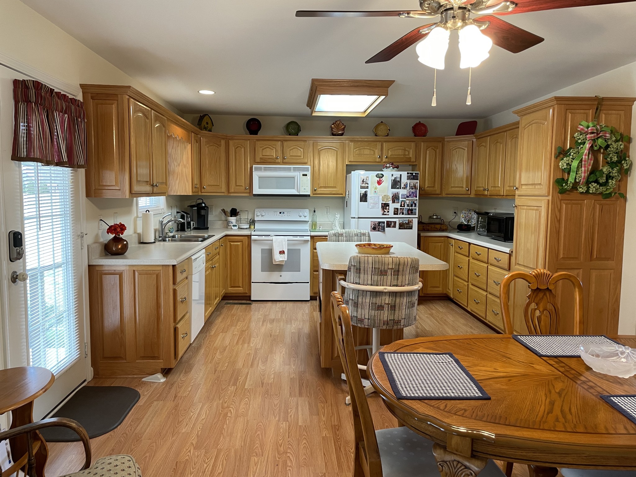 301 Rosson Street Summertown, TN 38483 - Photo 16 of 29 a kitchen with a table chairs refrigerator and cabinets