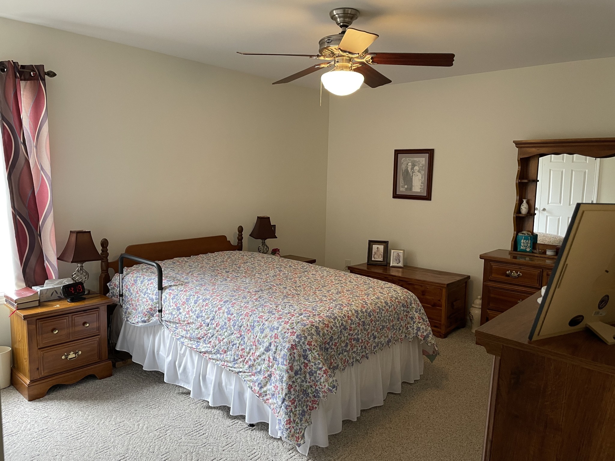301 Rosson Street Summertown, TN 38483 - Photo 18 of 29 a bedroom with a bed and a chandelier