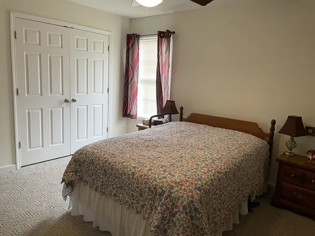 a bathroom with a granite countertop toilet a sink and a mirror