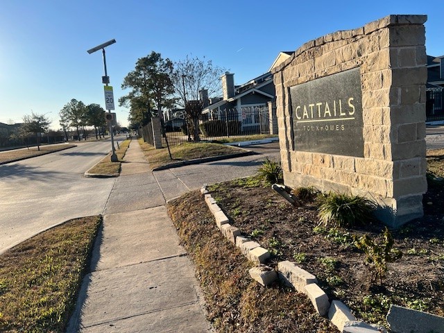 a sign board on the side of a street