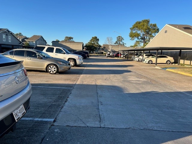 12245 Lemon Ridge Lane, Unit 122 Houston, TX 77035 - Photo 12 of 26 a view of a car parked on the side of the road