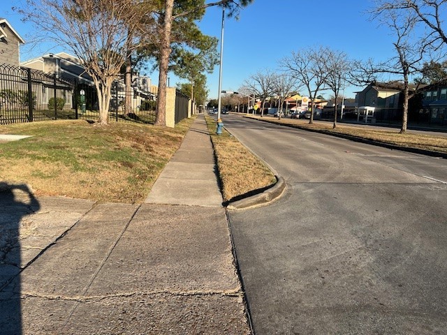 12245 Lemon Ridge Lane, Unit 122 Houston, TX 77035 - Photo 2 of 26 a view of a city street lined with buildings and trees