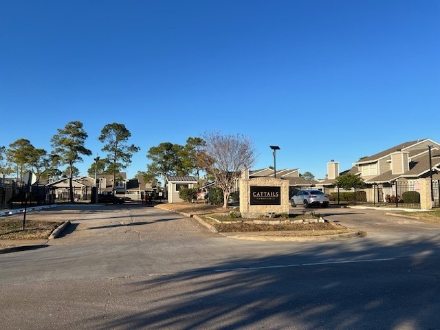 12245 Lemon Ridge Lane, Unit 122 Houston, TX 77035 - Photo 3 of 26 a front view of a building with parked cars