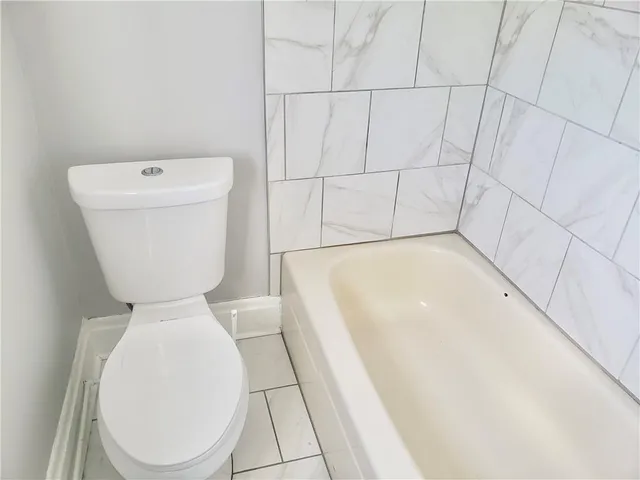 a bathroom with a toilet and a bathtub