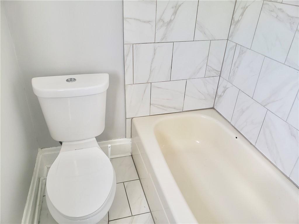 1234 Itin Street, Unit 5 Pittsburgh, PA 15212 - Photo 15 of 16 a bathroom with a toilet and a bathtub