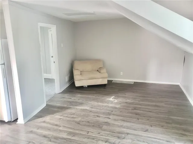 a view of room with wooden floor