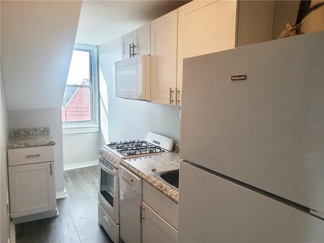 a kitchen with a stove and a refrigerator