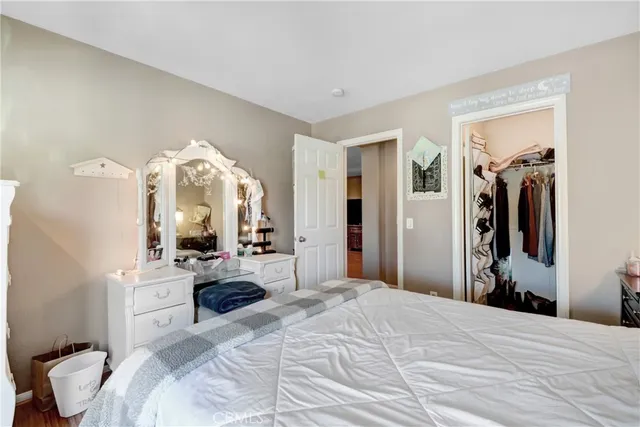 a bedroom with a bed and a mirror on dresser