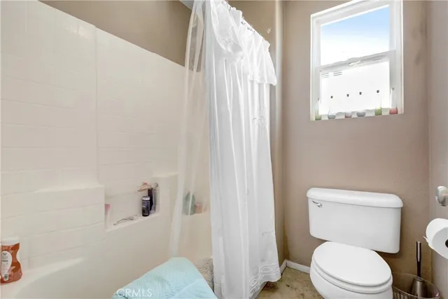 a en suite bathroom with a granite countertop sink and a mirror
