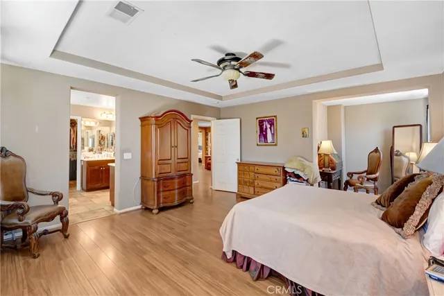 a work room with furniture a bookshelf and a window