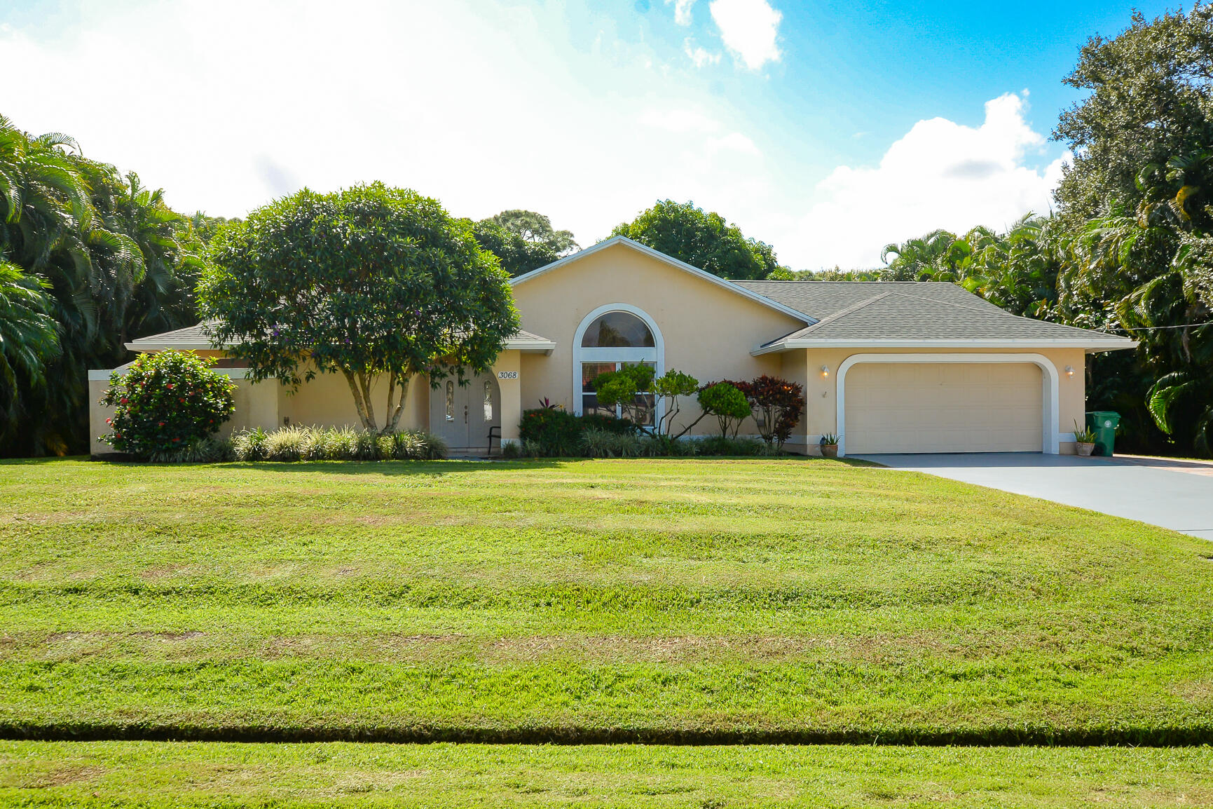 a front view of house with yard and green space