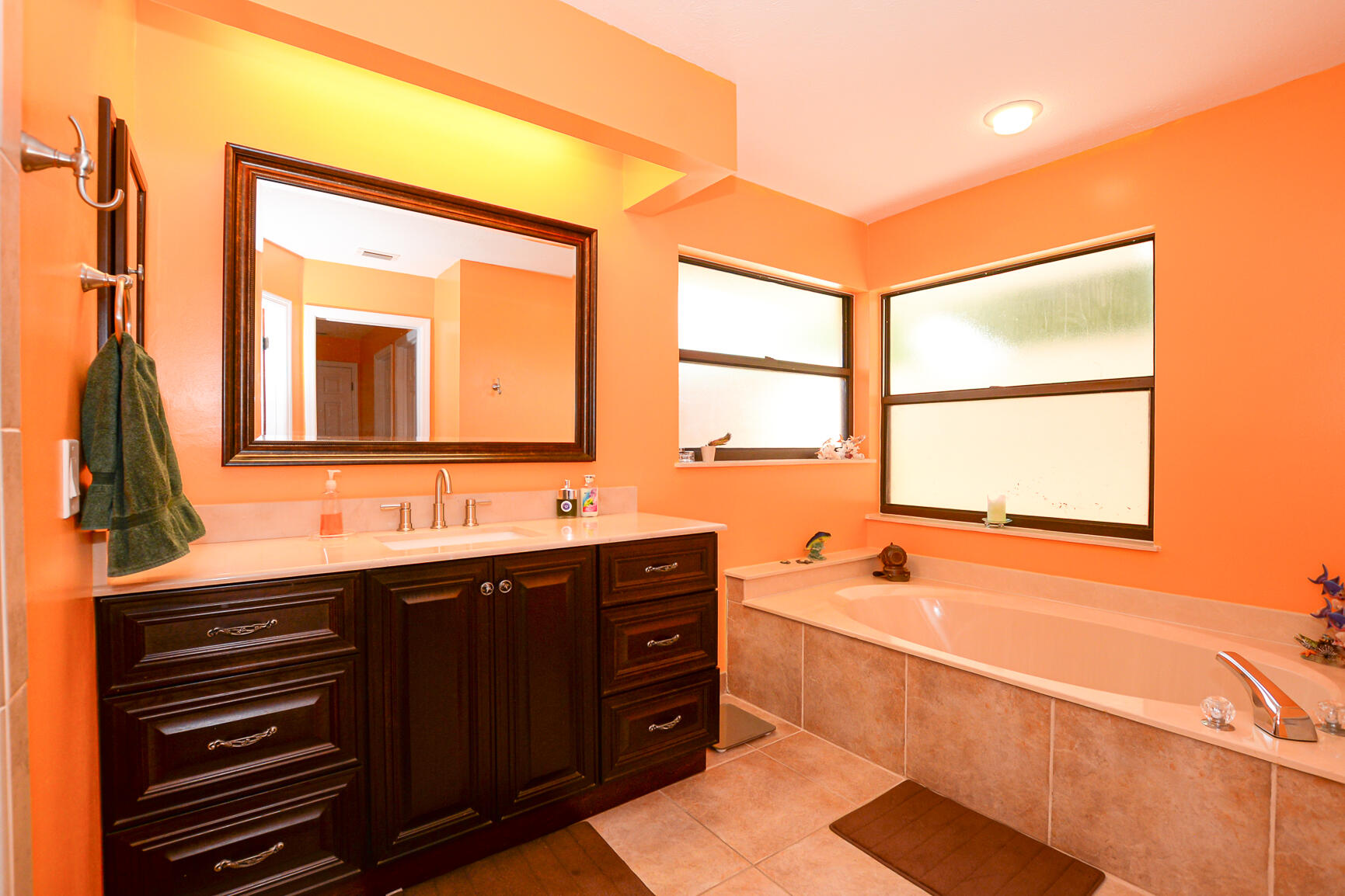 3068 Southeast Darien Road Port St. Lucie, FL 34952 - Photo 27 of 54 a bathroom with a double vanity sink bathtub and next to a window