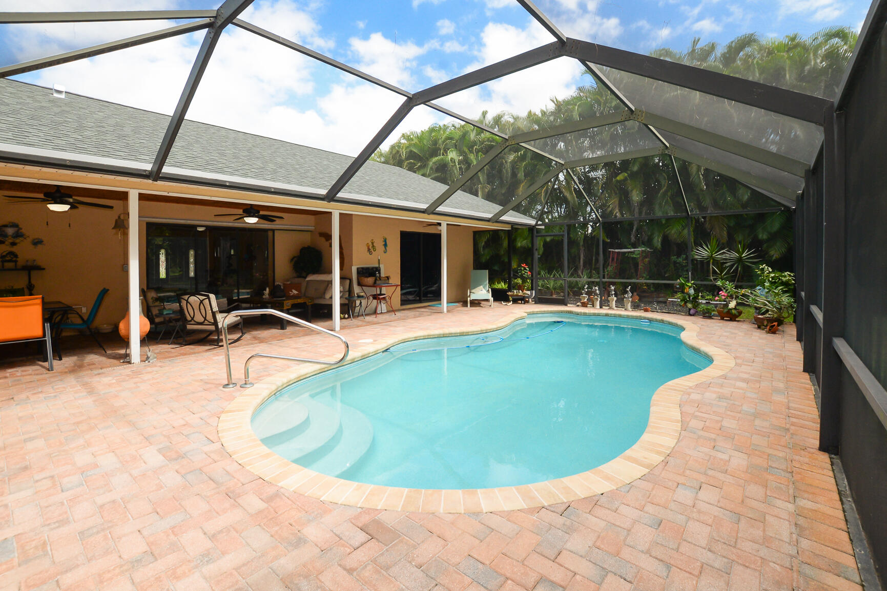 3068 Southeast Darien Road Port St. Lucie, FL 34952 - Photo 42 of 54 a view of a swimming pool with potted plants
