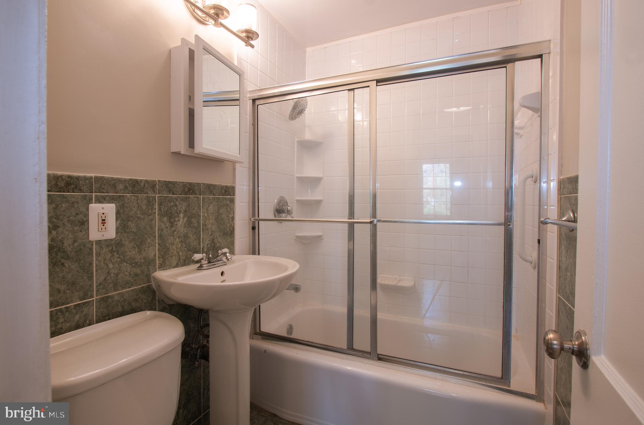 3404 Murdock Road Kensington, MD 20895 - Photo 11 of 24 a bathroom with a sink toilet and shower