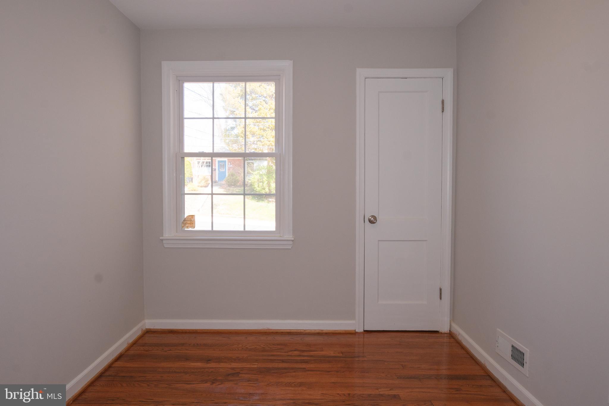 3404 Murdock Road Kensington, MD 20895 - Photo 12 of 24 an empty room with wooden floor and windows