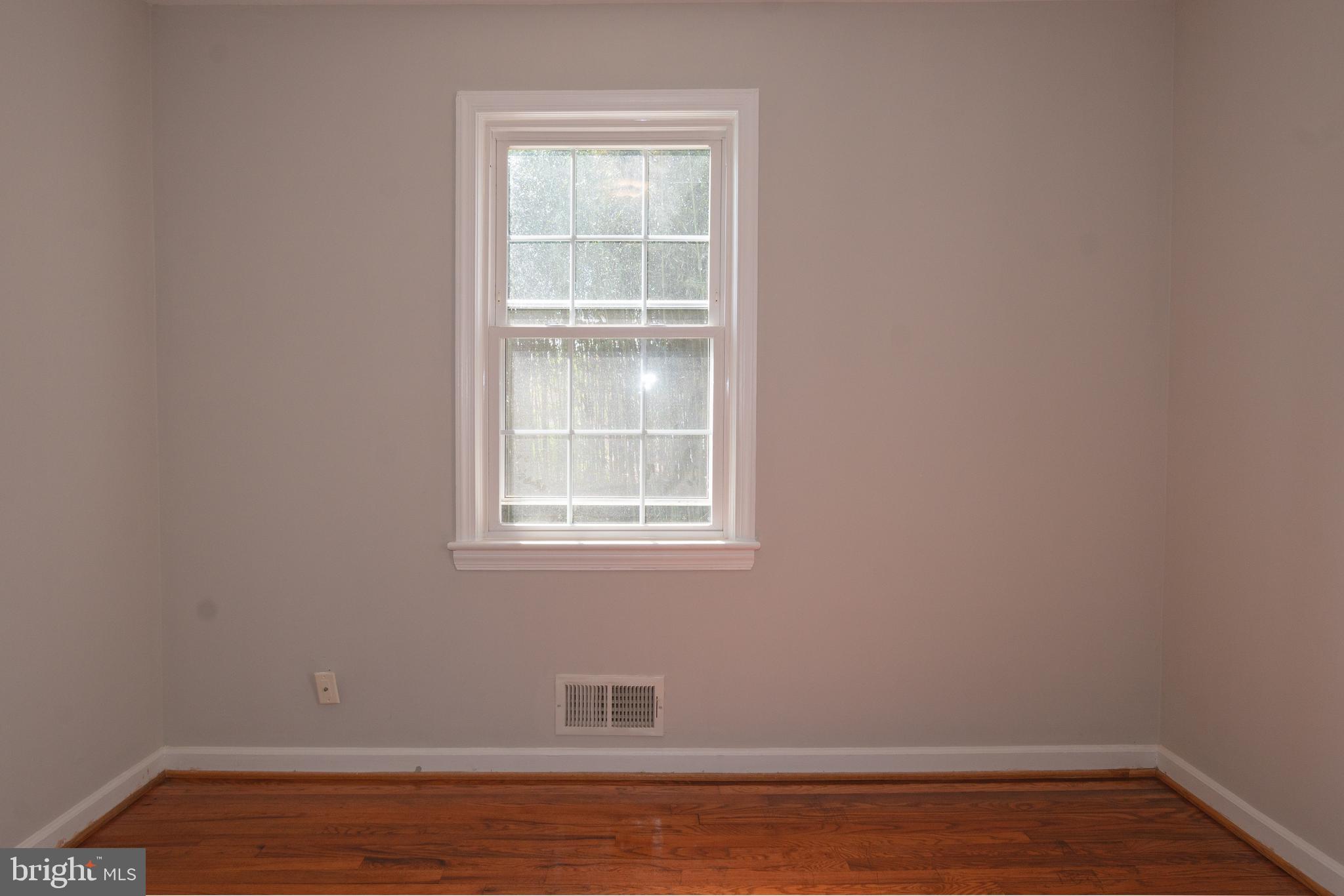 3404 Murdock Road Kensington, MD 20895 - Photo 14 of 24 a view of an empty room with wooden floor and a window