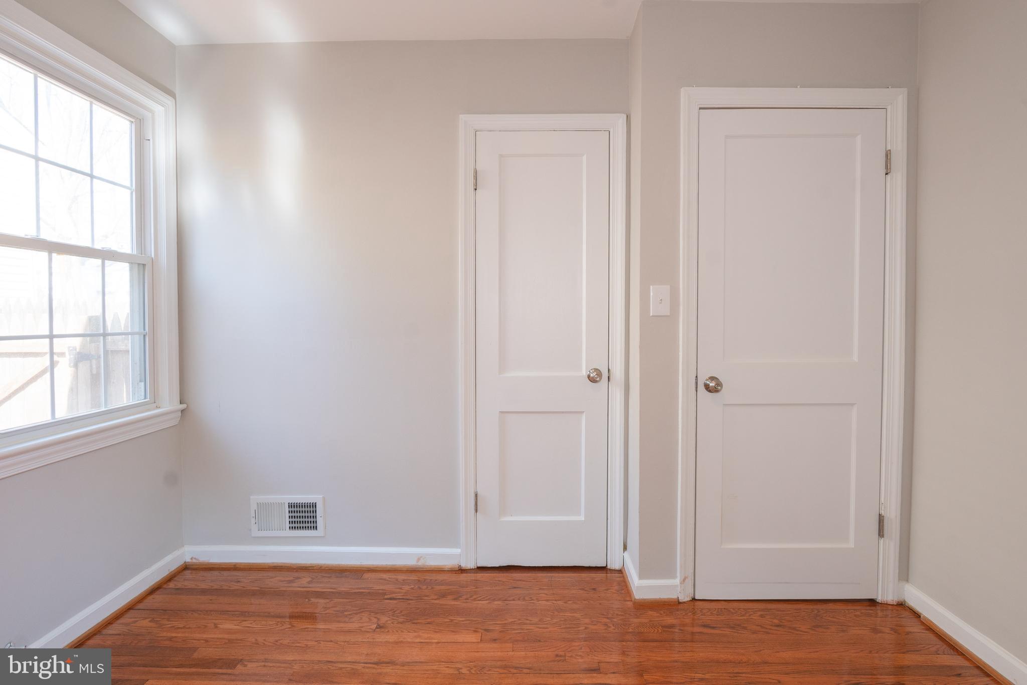 3404 Murdock Road Kensington, MD 20895 - Photo 15 of 24 an empty room with wooden floor and windows
