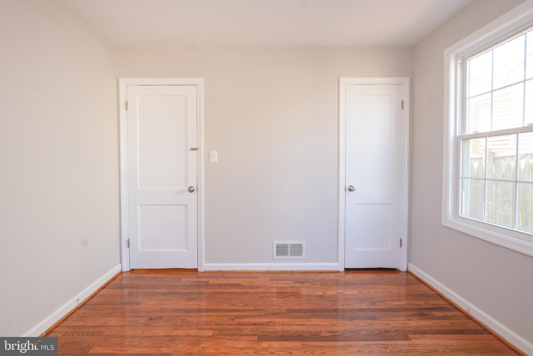 3404 Murdock Road Kensington, MD 20895 - Photo 17 of 24 an empty room with wooden floor and windows