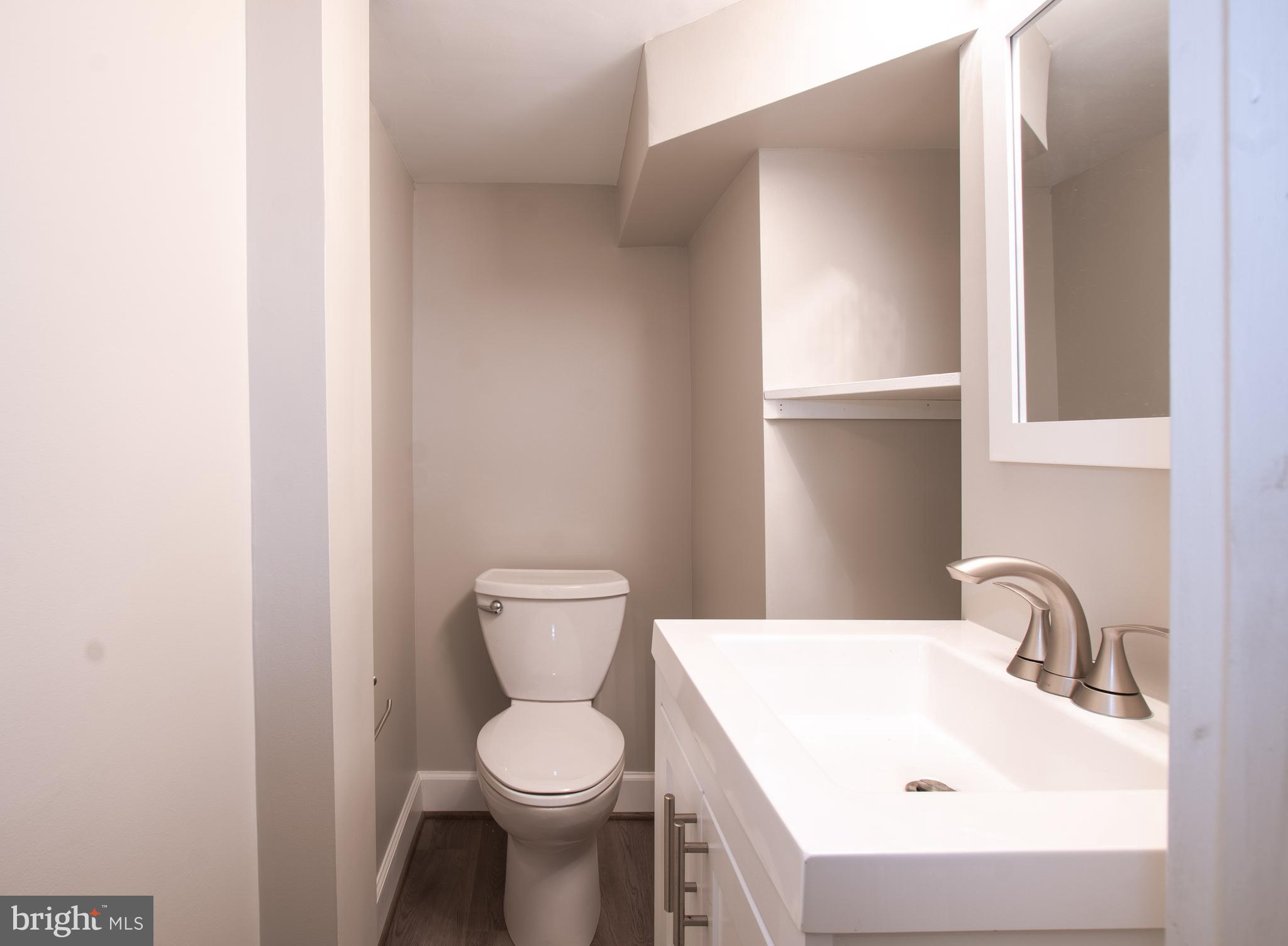 3404 Murdock Road Kensington, MD 20895 - Photo 21 of 24 a white toilet sitting next to a bathroom sink