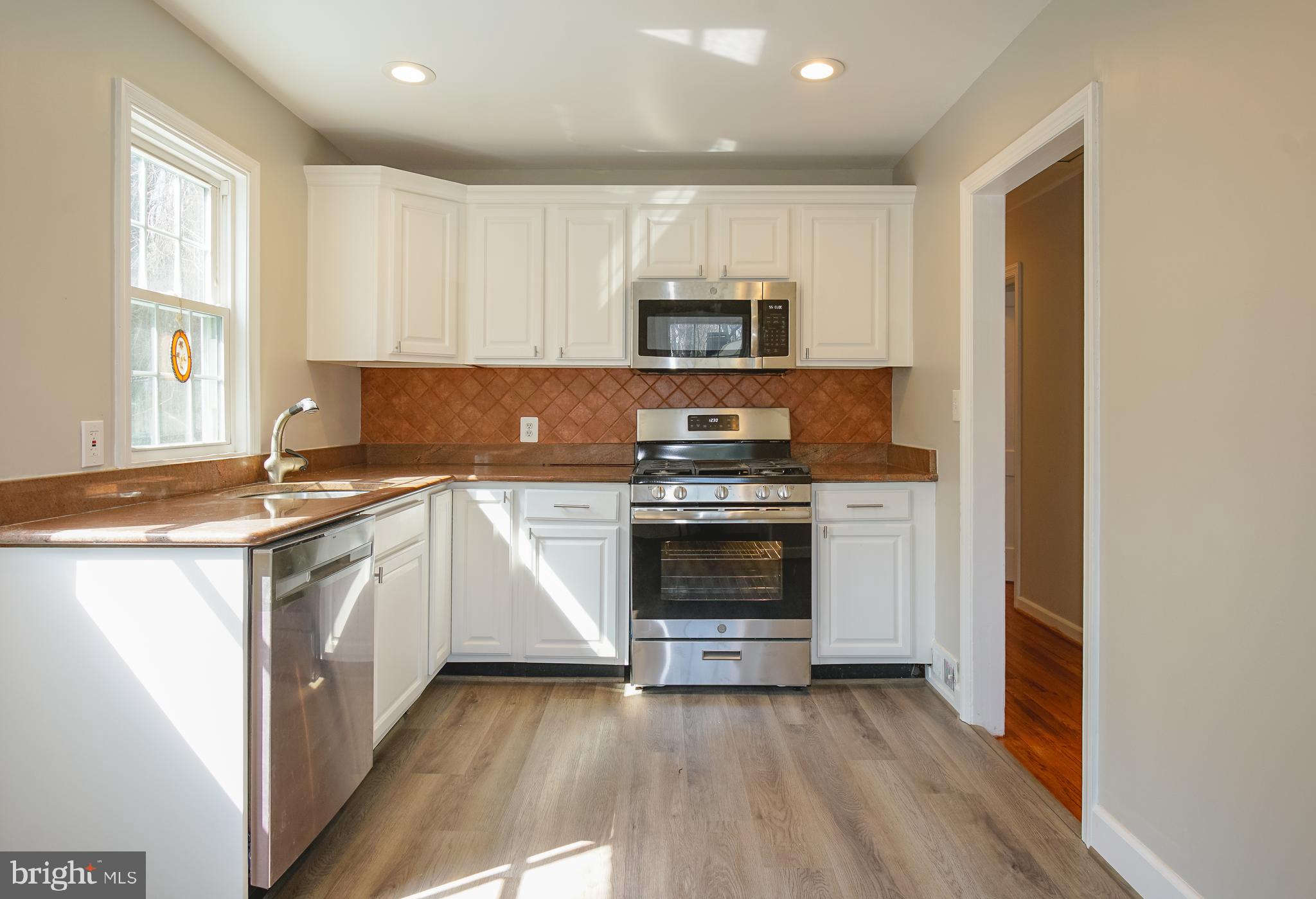 3404 Murdock Road Kensington, MD 20895 - Photo 7 of 24 a kitchen with stainless steel appliances a stove a sink and a microwave
