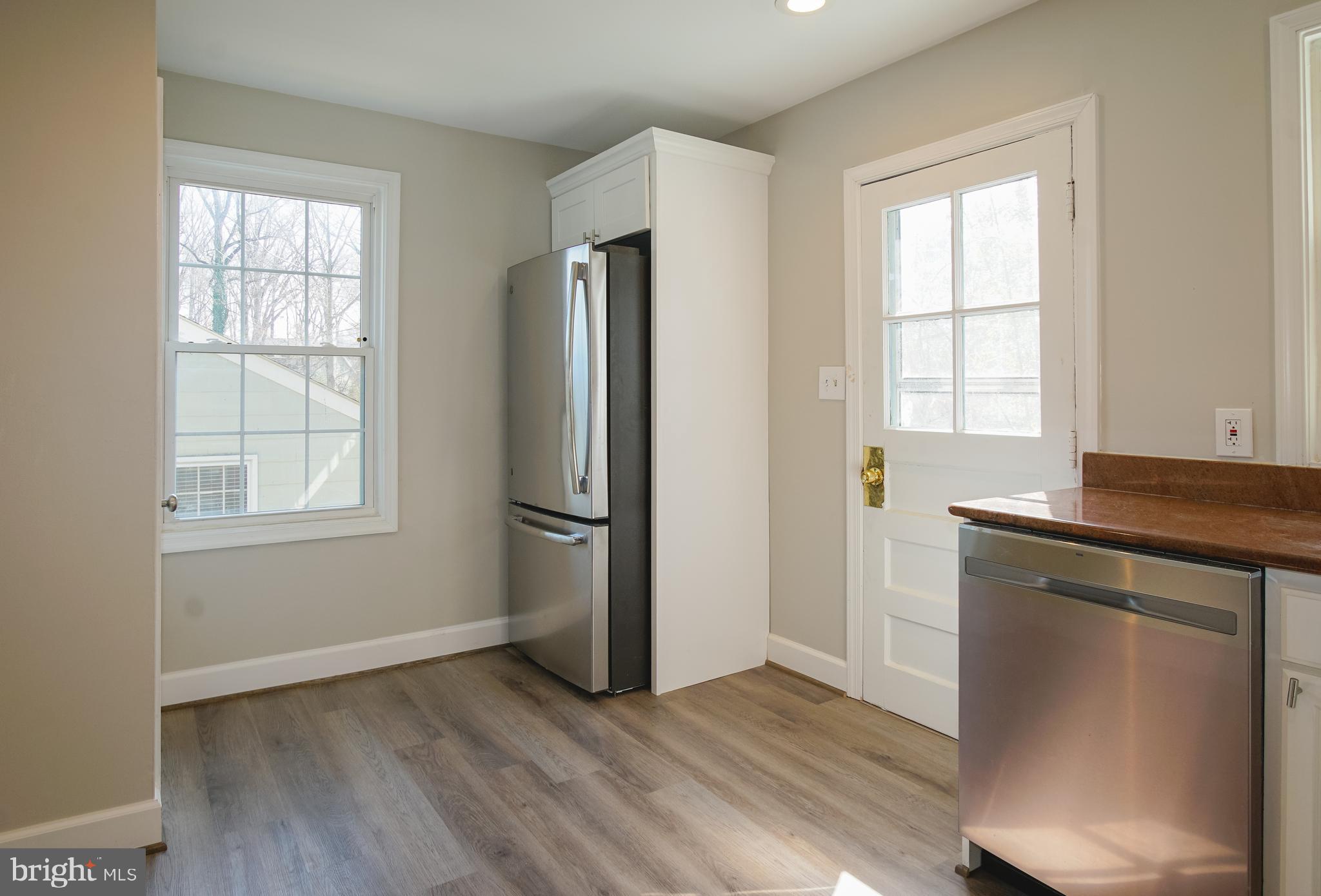 3404 Murdock Road Kensington, MD 20895 - Photo 9 of 24 an empty room with wooden floor and windows