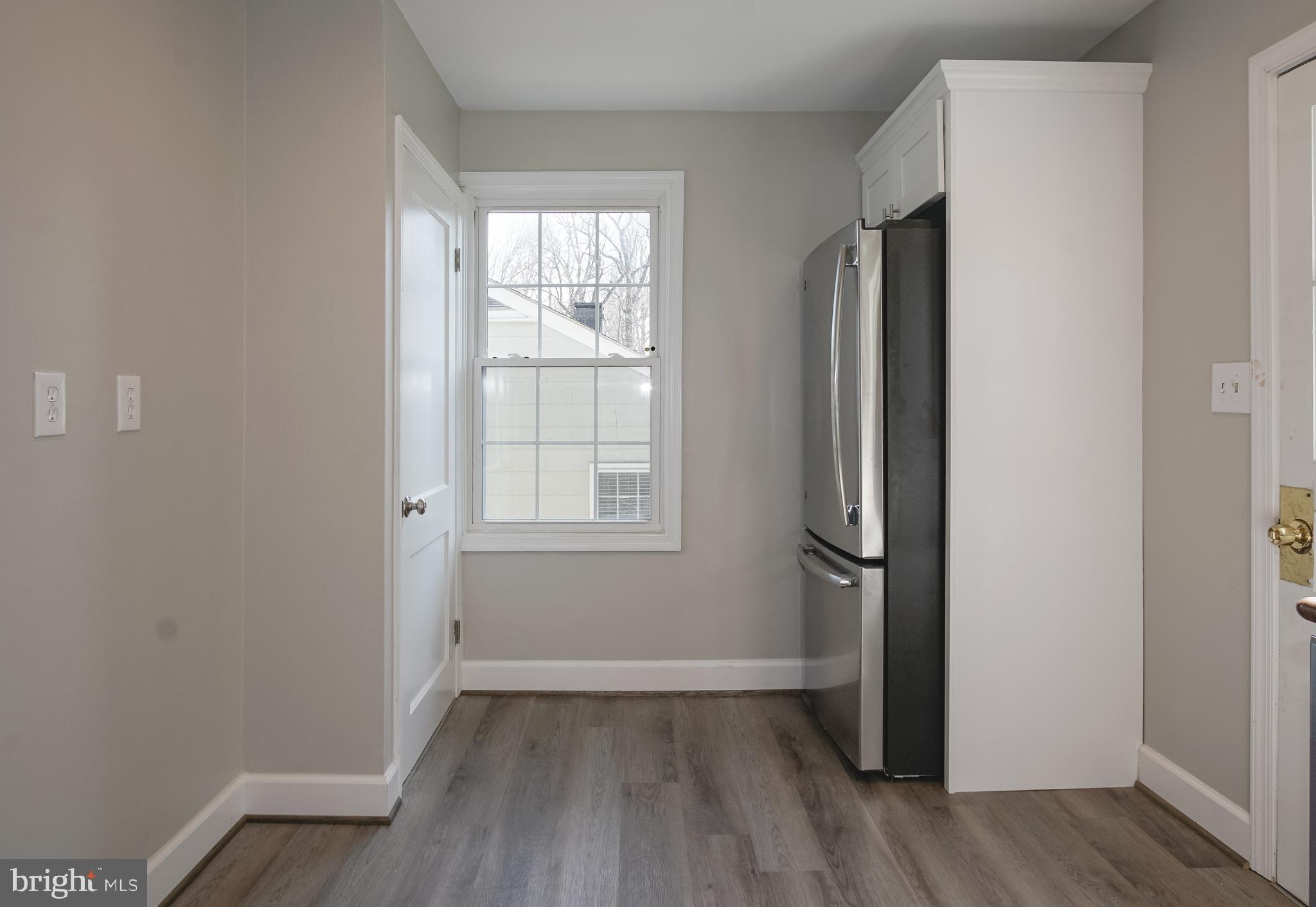 3404 Murdock Road Kensington, MD 20895 - Photo 10 of 24 an empty room with wooden floor and windows