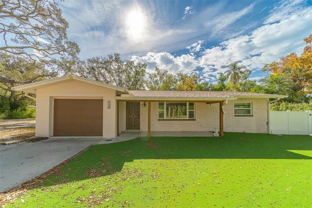 a front view of a house with a garden and yard