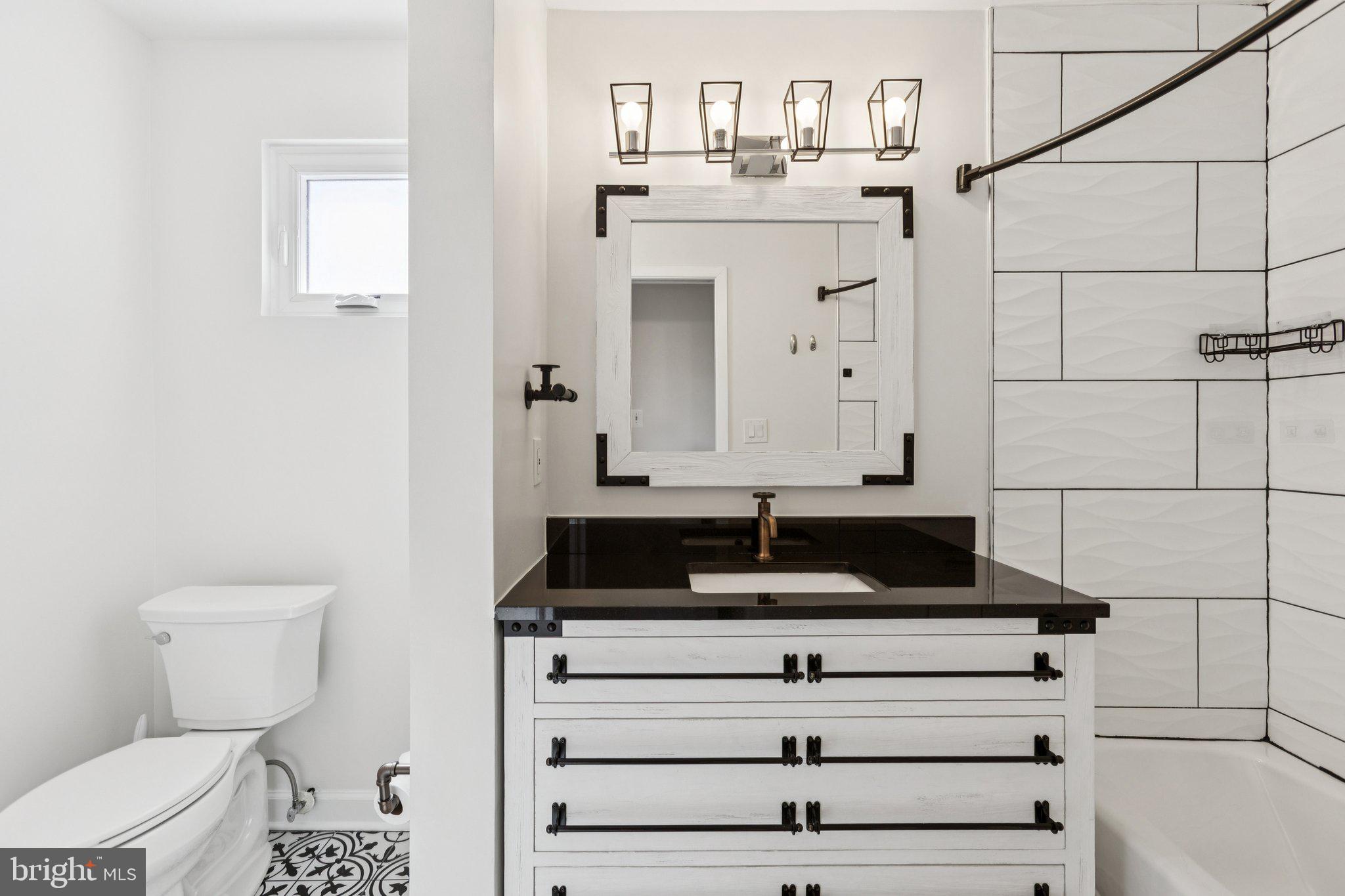 7435 8th Street Northwest Washington, DC 20012 - Photo 16 of 28 a bathroom with a sink and a toilet
