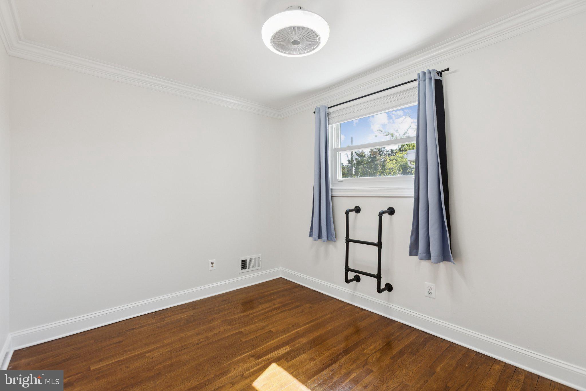 7435 8th Street Northwest Washington, DC 20012 - Photo 20 of 28 a view of an empty room with window and wooden floor