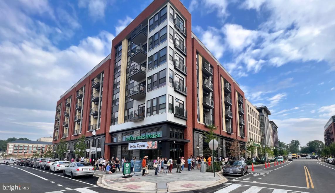 7435 8th Street Northwest Washington, DC 20012 - Photo 28 of 28 a city street lined with tall buildings and cars parked on the roadside