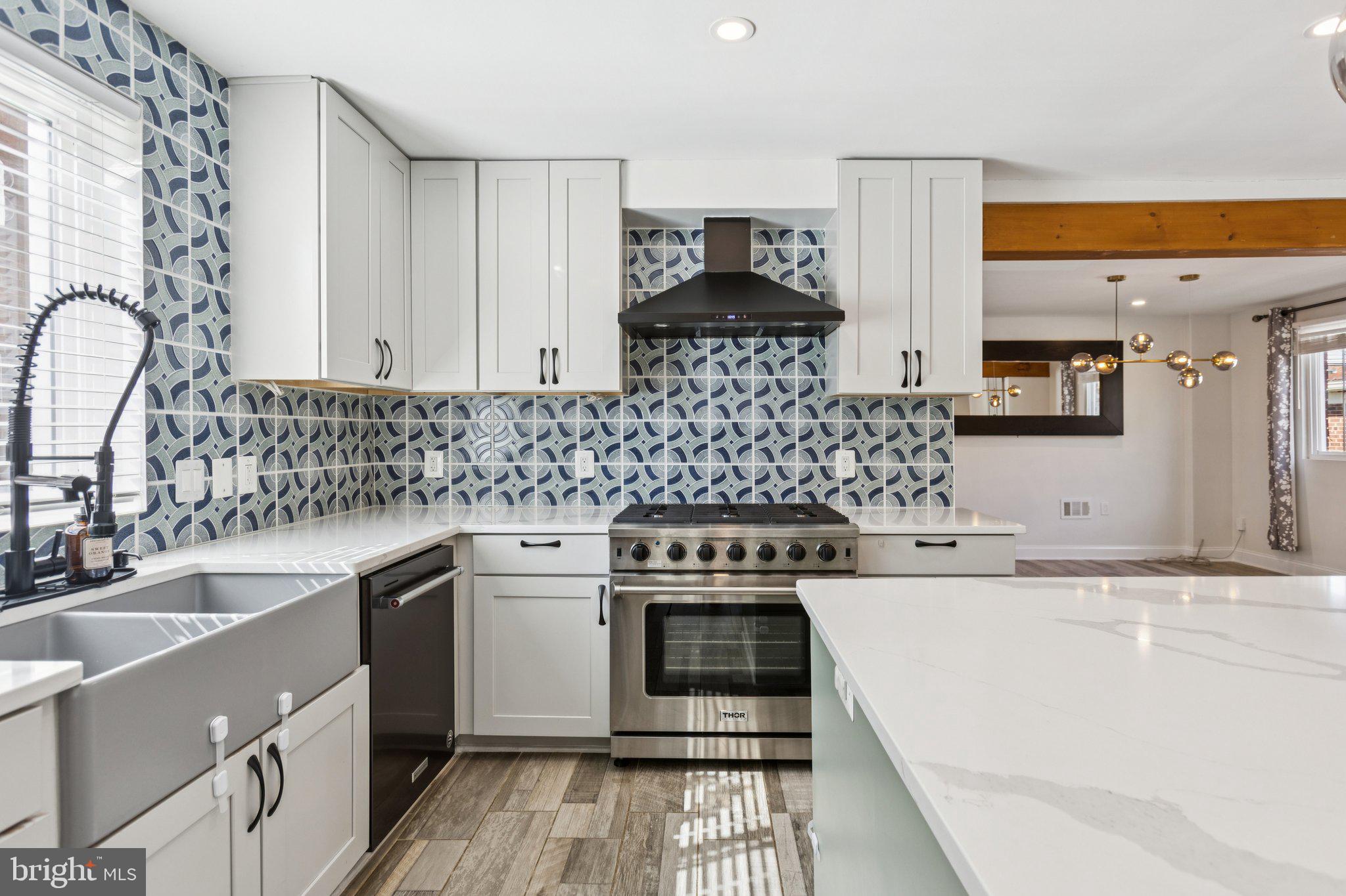 7435 8th Street Northwest Washington, DC 20012 - Photo 8 of 28 a kitchen with a sink stove and cabinets