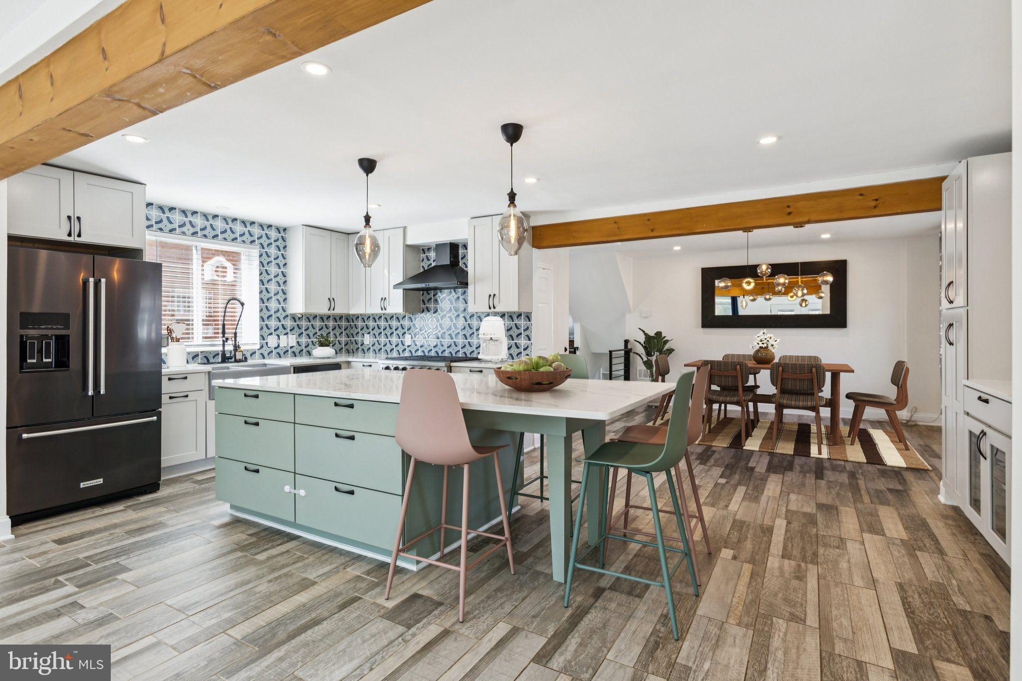 7435 8th Street Northwest Washington, DC 20012 - Photo 9 of 28 a kitchen with stainless steel appliances kitchen island granite countertop a table chairs and a refrigerator