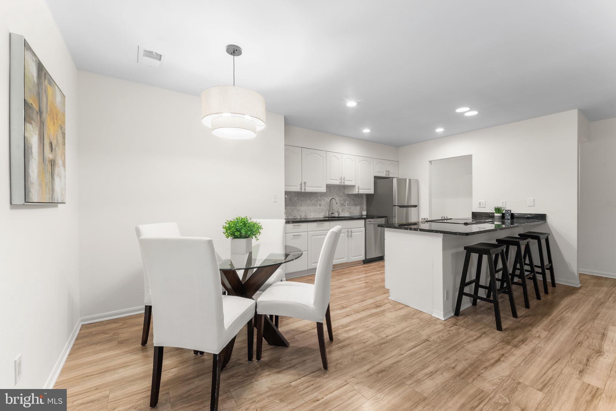 11401 Turnmill Lane Reston, VA 20191 - Photo 16 of 81 a view of a dining room with furniture and wooden floor