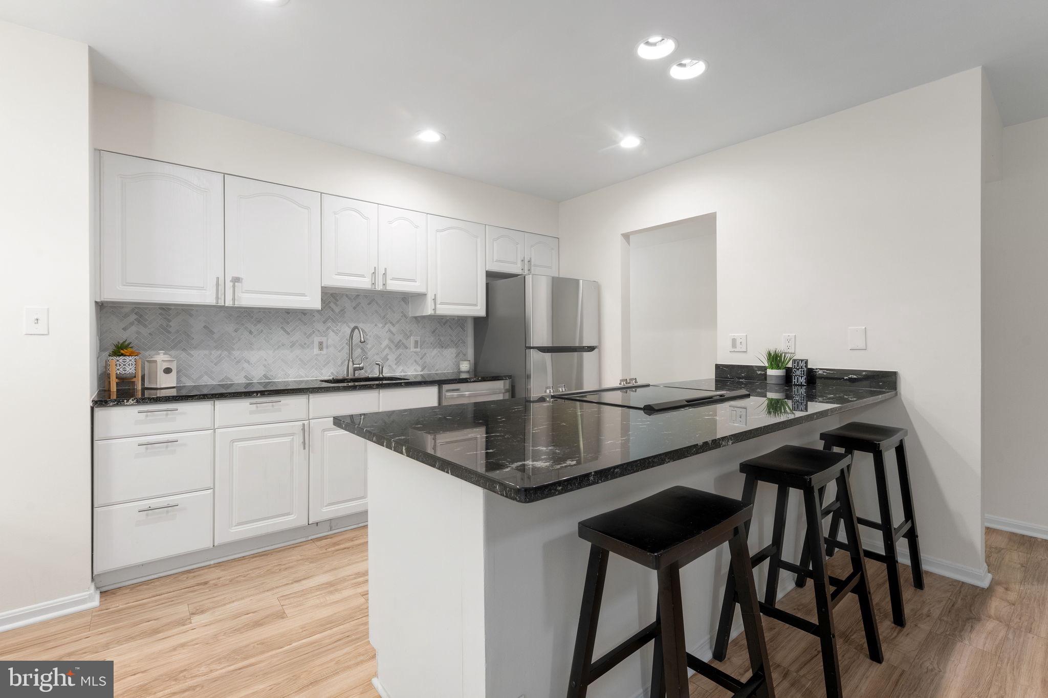 11401 Turnmill Lane Reston, VA 20191 - Photo 19 of 81 Sleek modern kitchen with elegant finishes.