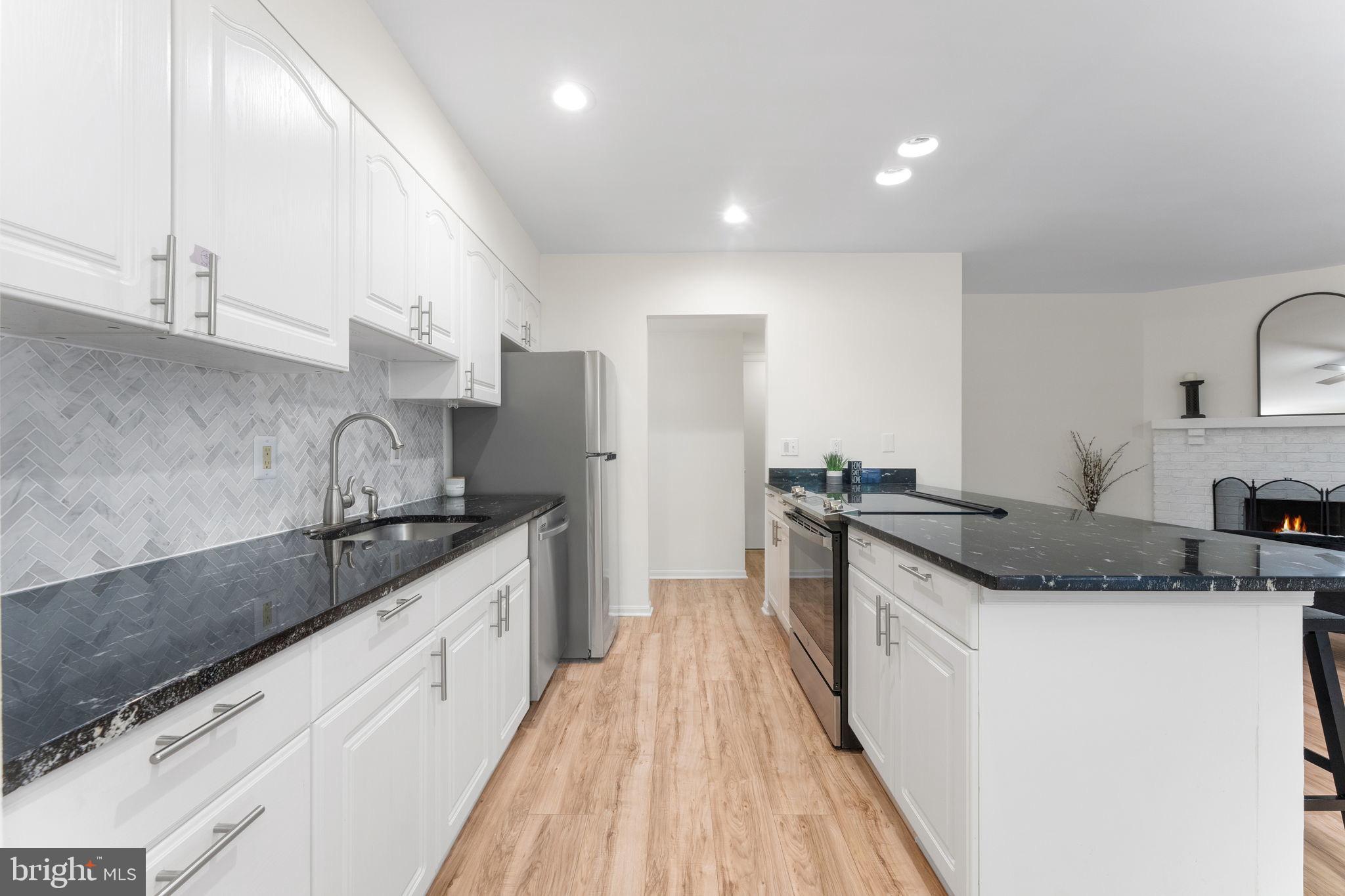 11401 Turnmill Lane Reston, VA 20191 - Photo 20 of 81 a kitchen with stainless steel appliances granite countertop a sink and a stove top oven