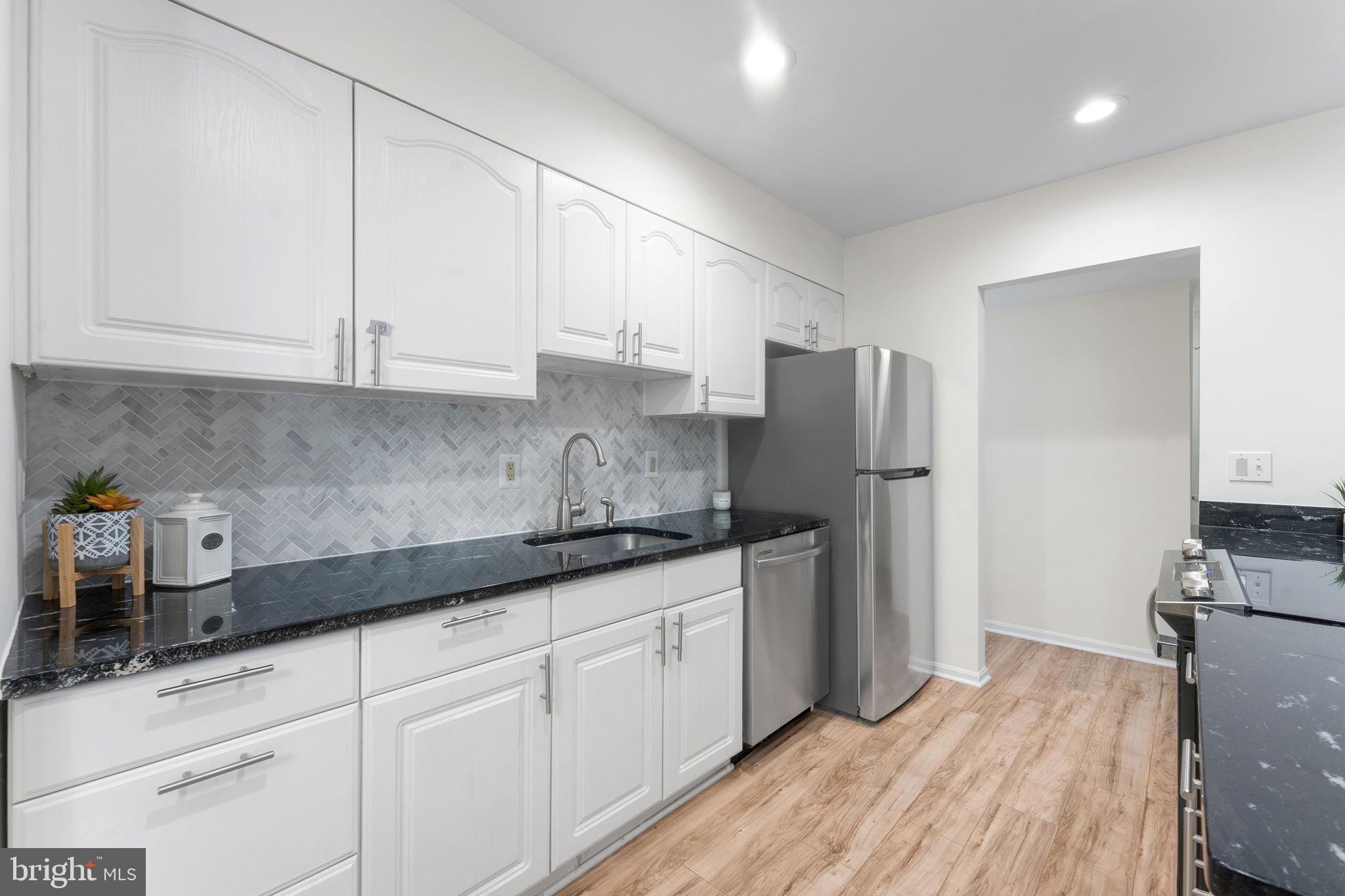 11401 Turnmill Lane Reston, VA 20191 - Photo 21 of 81 a kitchen with stainless steel appliances granite countertop a refrigerator sink and cabinets