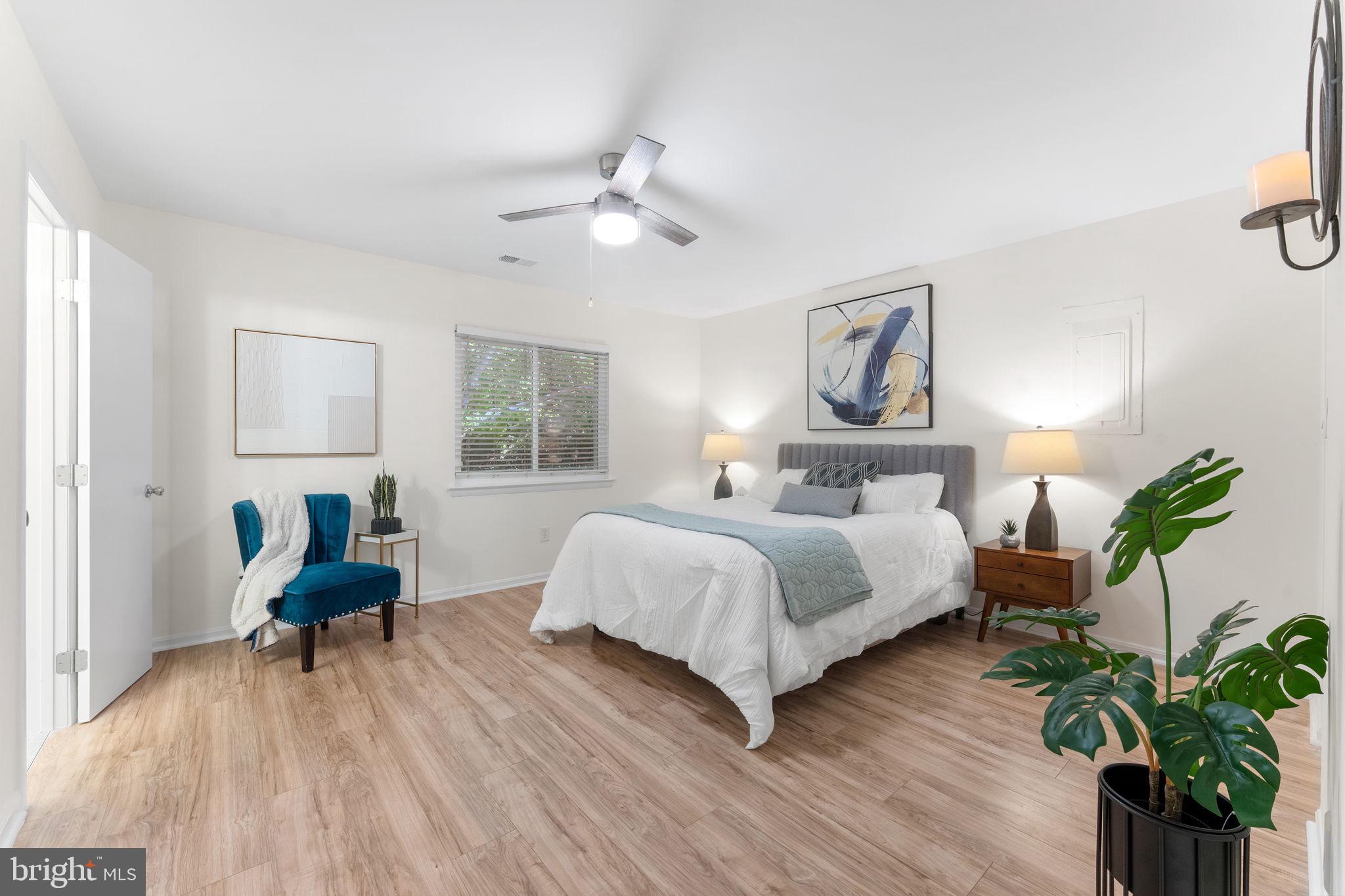 11401 Turnmill Lane Reston, VA 20191 - Photo 26 of 81 a bedroom with a bed table chair and a window