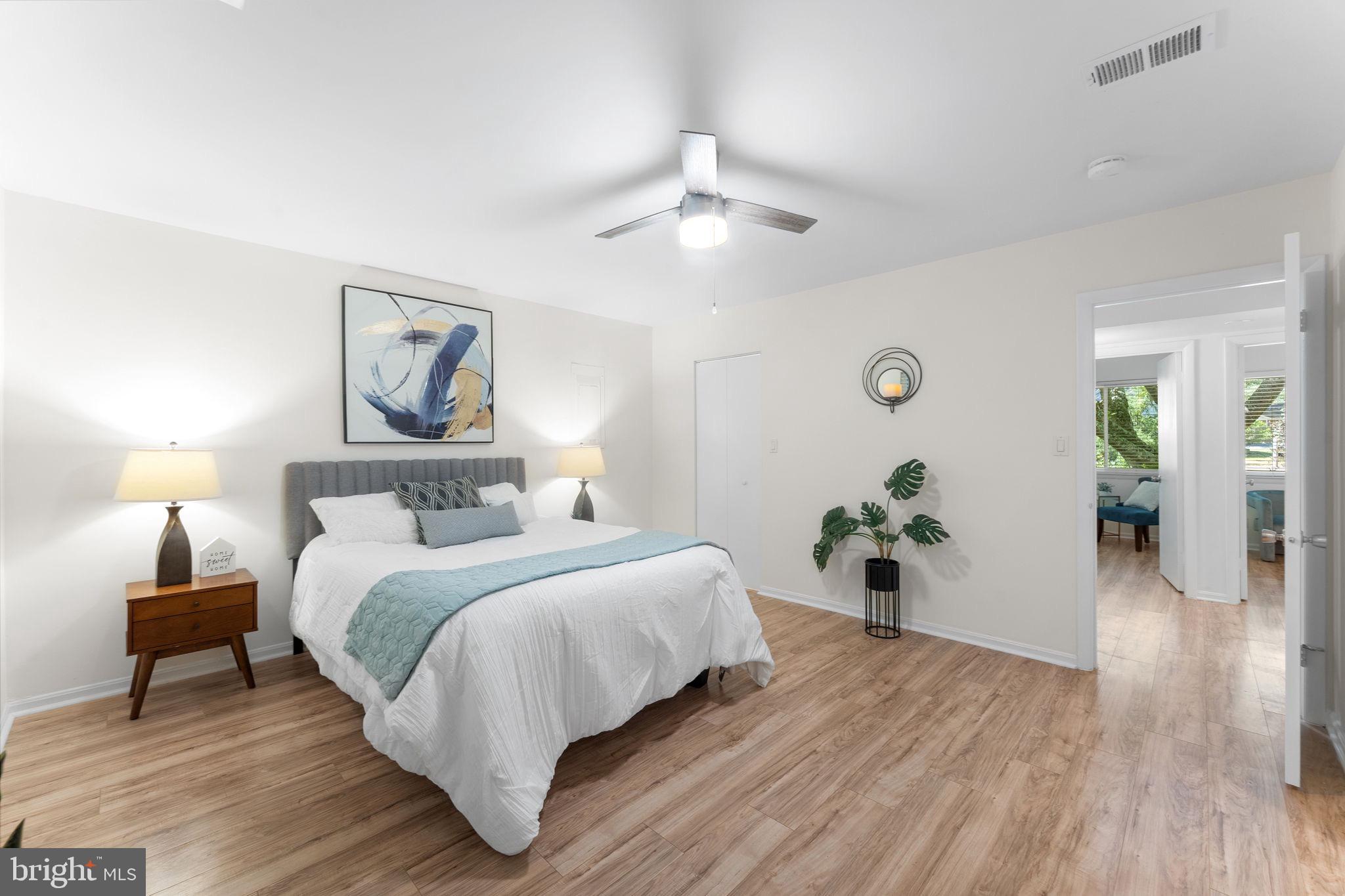 11401 Turnmill Lane Reston, VA 20191 - Photo 27 of 81 a bedroom with a large bed and a chandelier