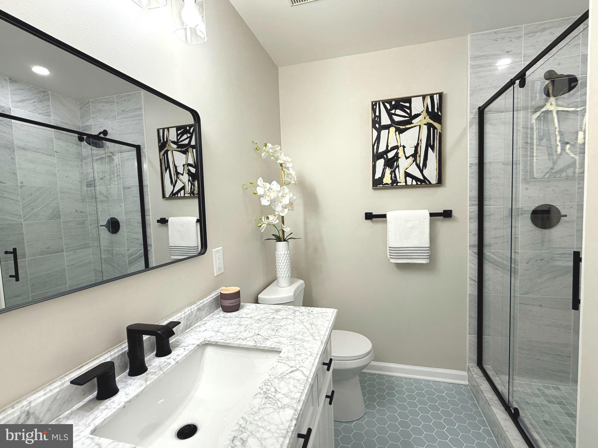 11401 Turnmill Lane Reston, VA 20191 - Photo 30 of 81 a bathroom with a sink and a mirror