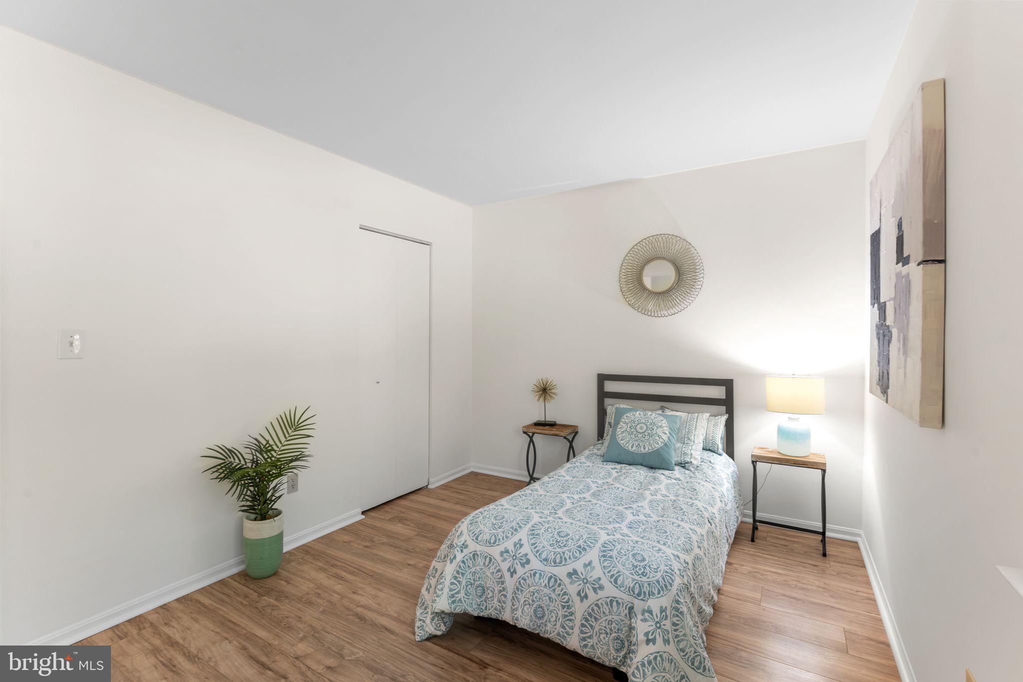 11401 Turnmill Lane Reston, VA 20191 - Photo 37 of 81 a bedroom with a bed and a potted plant