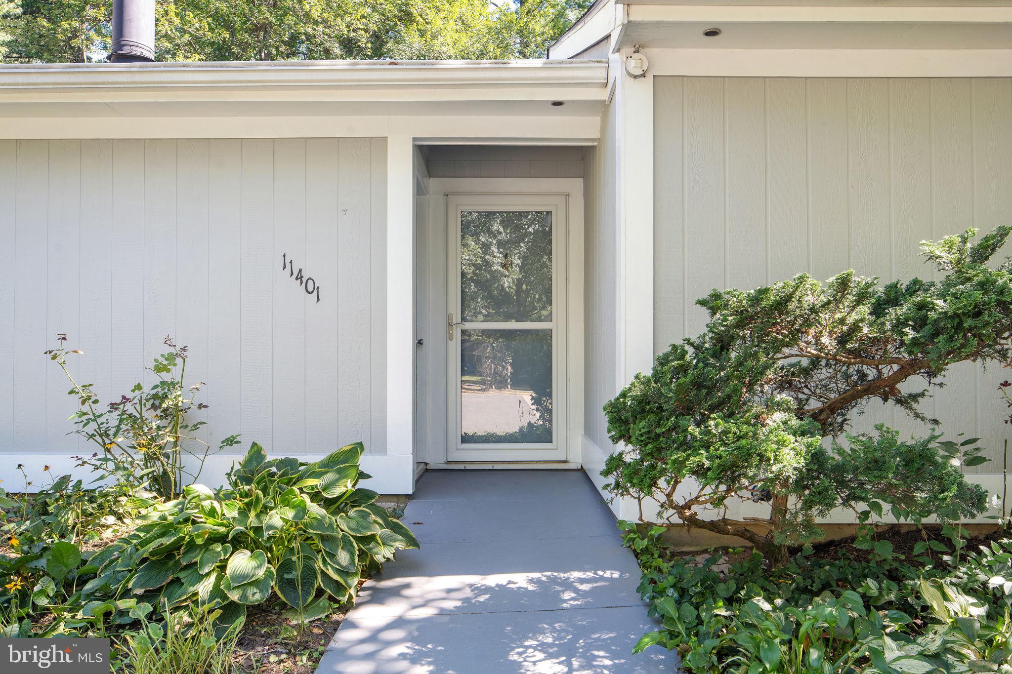 11401 Turnmill Lane Reston, VA 20191 - Photo 4 of 81 Charming entrance with lush greenery.