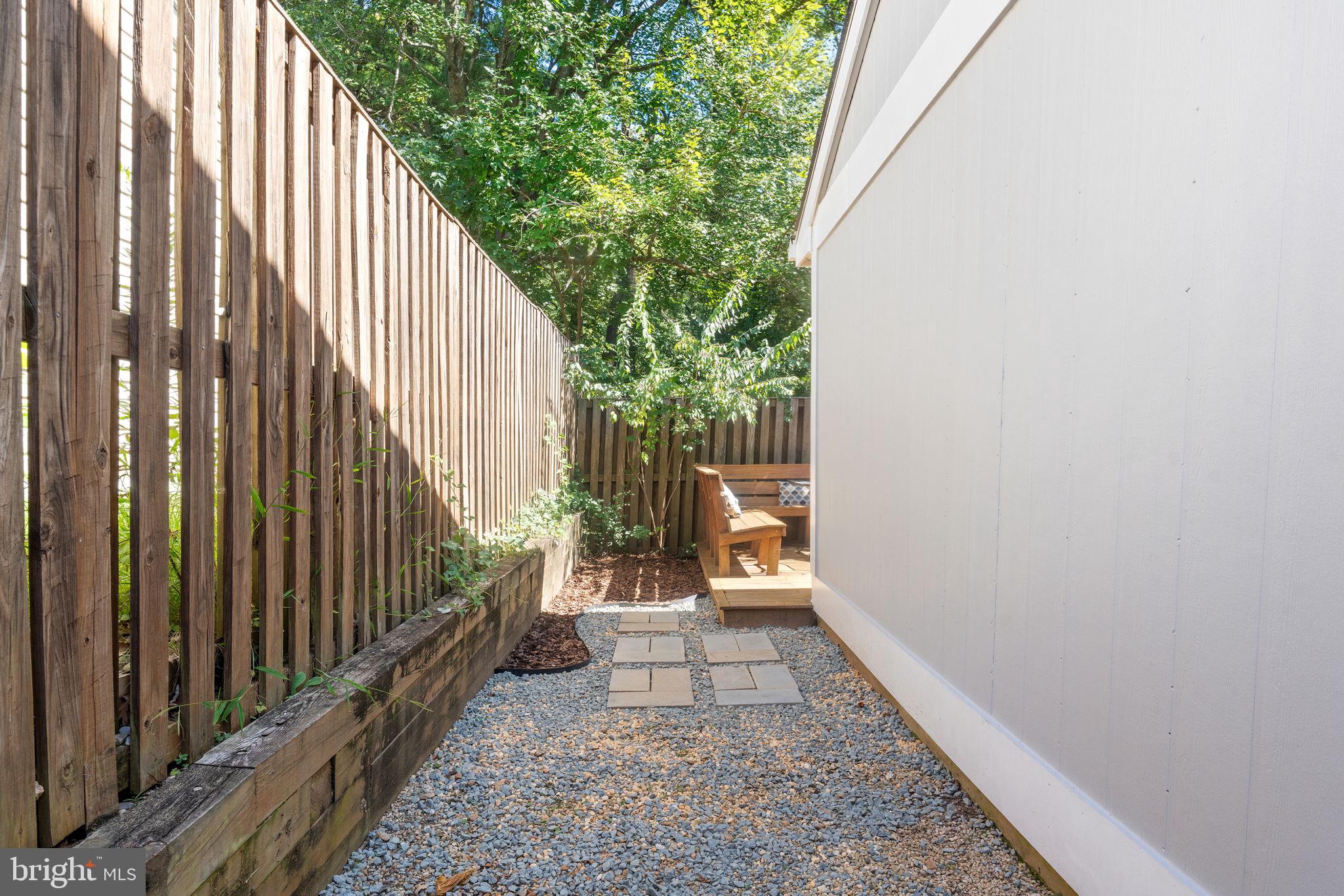 11401 Turnmill Lane Reston, VA 20191 - Photo 41 of 81 Serene garden path with natural greenery.