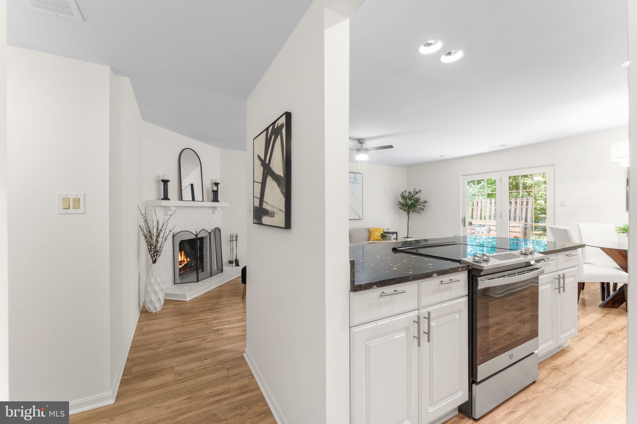 11401 Turnmill Lane Reston, VA 20191 - Photo 5 of 81 Inviting open layout with cozy fireplace.